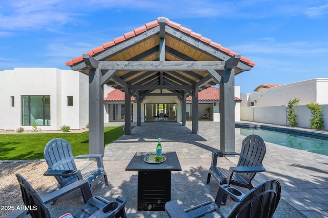 view of patio featuring a gazebo, a fenced in pool, and fence