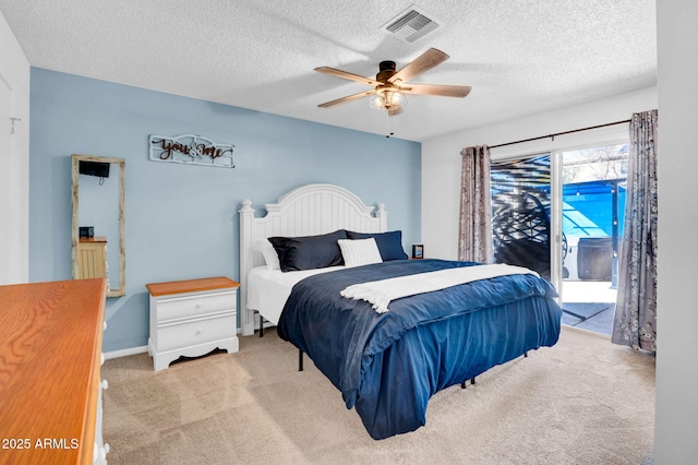 carpeted bedroom featuring visible vents, baseboards, a ceiling fan, access to outside, and a textured ceiling