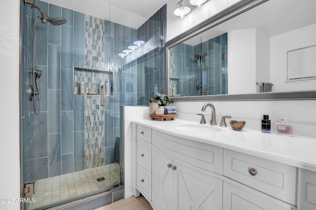 bathroom featuring a shower stall and vanity