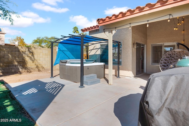 view of patio / terrace featuring a pergola, fence, and a hot tub