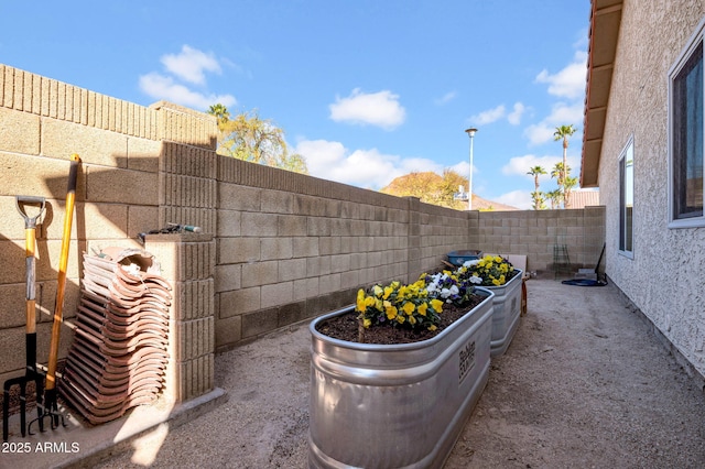 exterior space with a garden and a fenced backyard