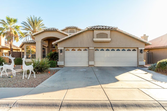 mediterranean / spanish-style house with a garage