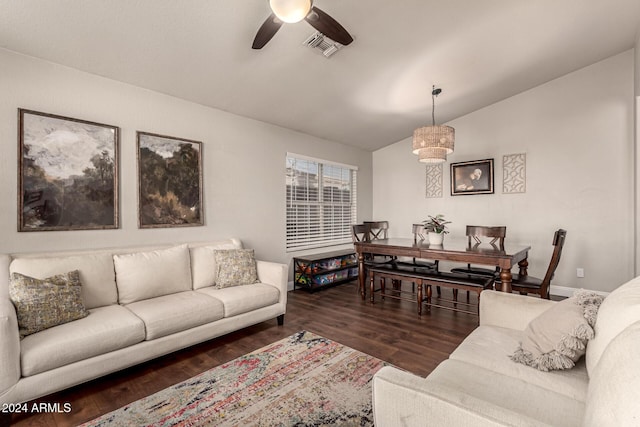 living room featuring dark hardwood / wood-style floors, vaulted ceiling, and ceiling fan