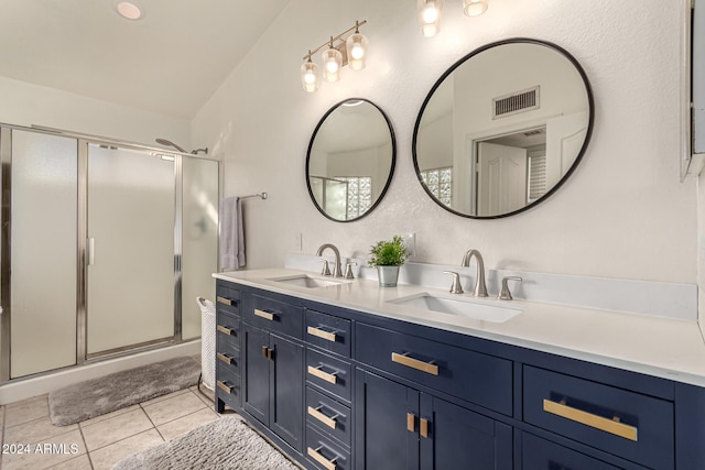 bathroom featuring tile patterned flooring, vanity, and a shower with door