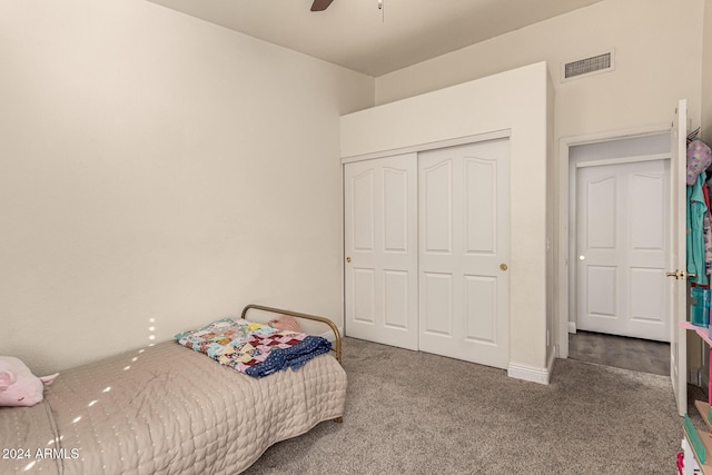 carpeted bedroom featuring a closet and ceiling fan