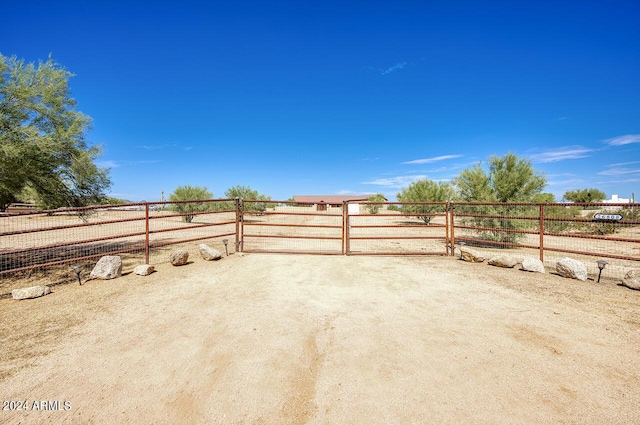 view of yard featuring a rural view and fence