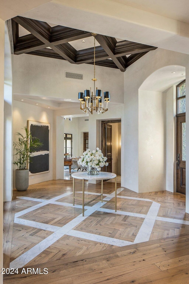 dining room featuring parquet floors, a high ceiling, coffered ceiling, beamed ceiling, and an inviting chandelier