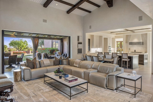 living room featuring a wealth of natural light, beam ceiling, and high vaulted ceiling