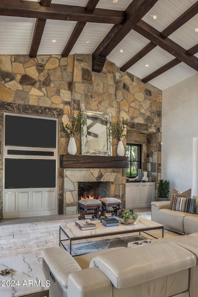 living room featuring beam ceiling, high vaulted ceiling, and a fireplace