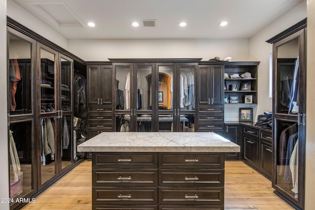 walk in closet featuring light hardwood / wood-style flooring