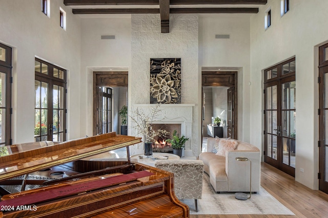 living room featuring french doors, hardwood / wood-style flooring, and beam ceiling