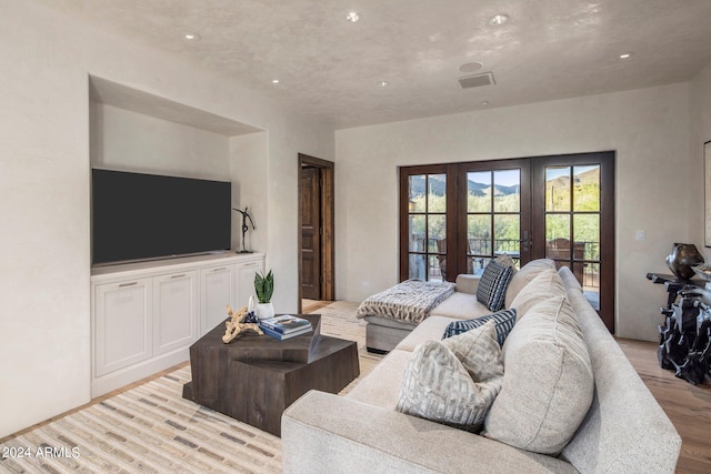 living room with light hardwood / wood-style floors and french doors