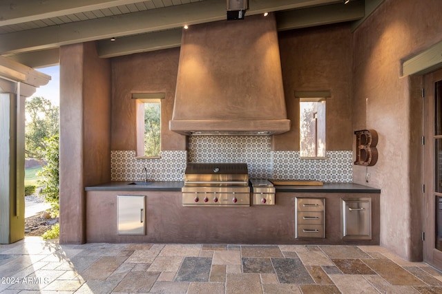 kitchen with backsplash, sink, tile flooring, and vaulted ceiling with beams