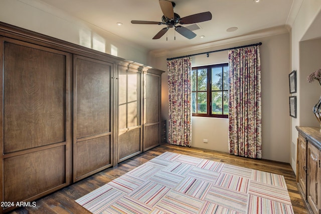 unfurnished bedroom with hardwood / wood-style floors, ceiling fan, and ornamental molding