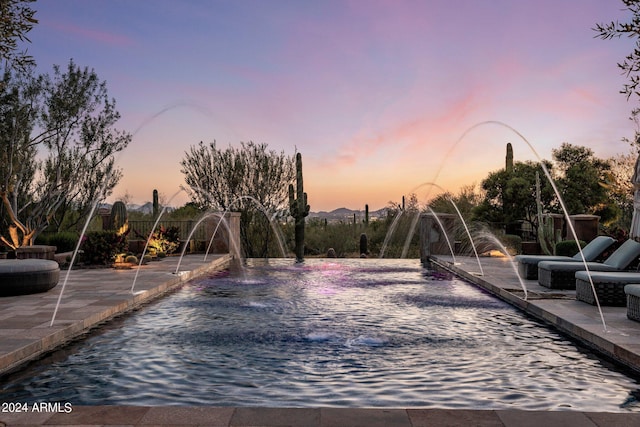 view of pool at dusk