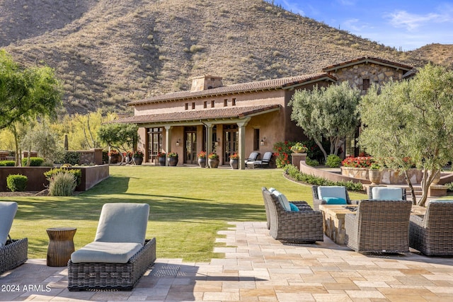 rear view of house featuring a patio, a yard, and central AC unit