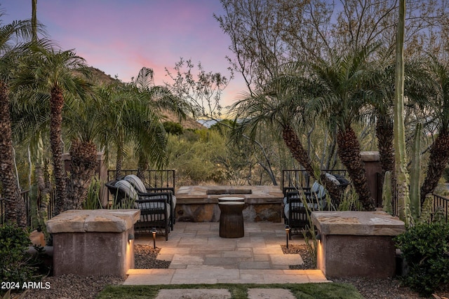 view of patio terrace at dusk