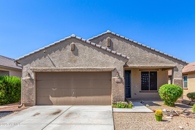 18008 W Tina Ln, Surprise, AZ 85387 - view of front facade featuring an attached garage, stucco siding, driveway, and a tile roof