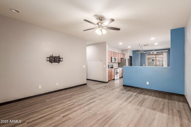 18008 W Tina Ln, Surprise, AZ 85387 - unfurnished living room with ceiling fan, light wood finished floors, baseboards, and recessed lighting
