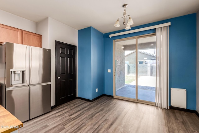 18008 W Tina Ln, Surprise, AZ 85387 - kitchen with stainless steel refrigerator with ice dispenser, wood finished floors, a chandelier, and baseboards