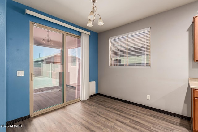18008 W Tina Ln, Surprise, AZ 85387 - spare room featuring wood finished floors and healthy amount of natural light