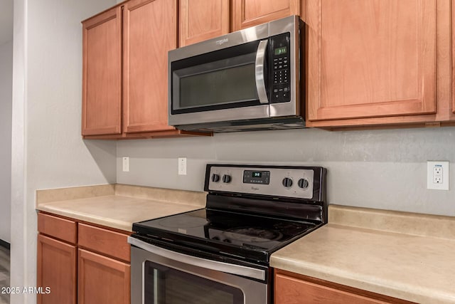 18008 W Tina Ln, Surprise, AZ 85387 - kitchen with appliances with stainless steel finishes and light countertops
