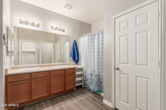 18008 W Tina Ln, Surprise, AZ 85387 - full bathroom featuring wood finished floors, double vanity, and curtained shower