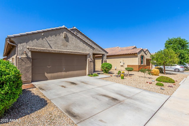 18008 W Tina Ln, Surprise, AZ 85387 - view of front of property featuring stucco siding, a garage, a tile roof, and driveway