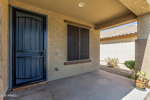 18008 W Tina Ln, Surprise, AZ 85387 - doorway to property featuring stucco siding and a patio area