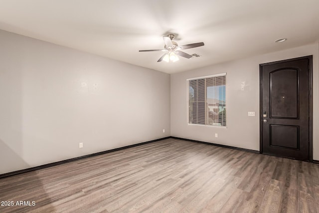 18008 W Tina Ln, Surprise, AZ 85387 - empty room with a ceiling fan, wood finished floors, and baseboards