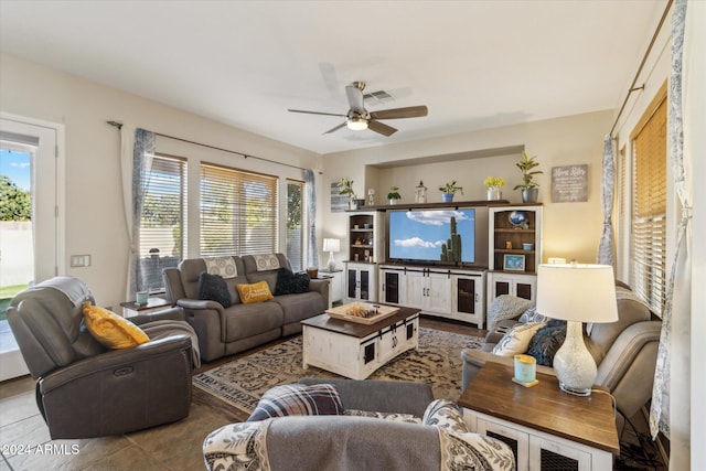 tiled living room featuring ceiling fan and a healthy amount of sunlight