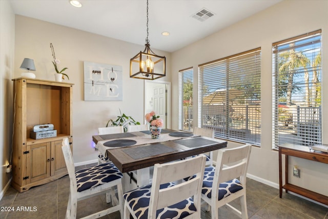 tiled dining area with a notable chandelier