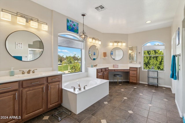 bathroom featuring a washtub, vanity, an inviting chandelier, and tile patterned floors