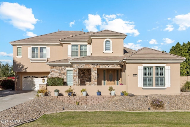 view of front of home featuring a garage and a front yard