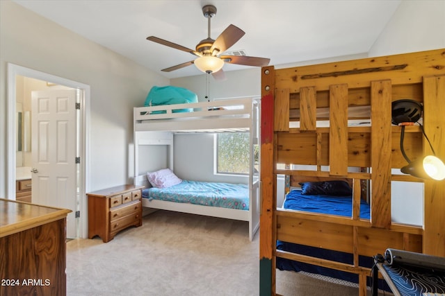 carpeted bedroom featuring ensuite bath and ceiling fan