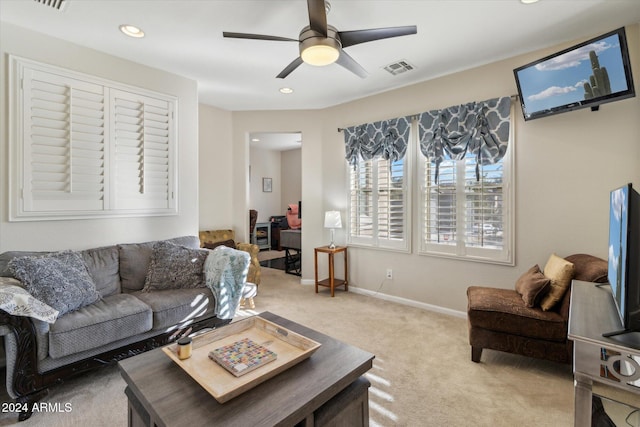 living room with ceiling fan and carpet