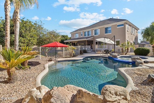 view of swimming pool with a patio area and an in ground hot tub