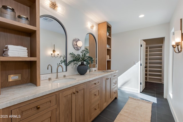3186 E Stella Ln, Phoenix, AZ 85016 - full bathroom with double vanity, tile patterned floors, a walk in closet, recessed lighting, and baseboards