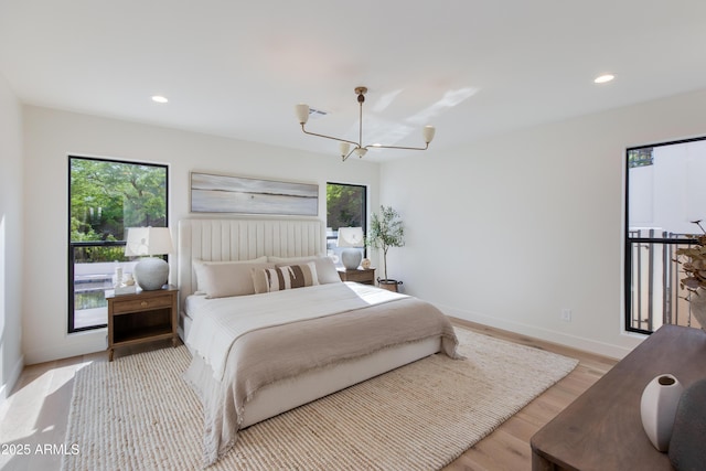 3186 E Stella Ln, Phoenix, AZ 85016 - bedroom with multiple windows, baseboards, a chandelier, light wood finished floors, and recessed lighting