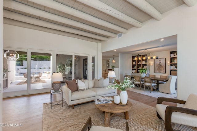 3186 E Stella Ln, Phoenix, AZ 85016 - living area with a chandelier, light wood-style floors, and wooden ceiling with exposed beams