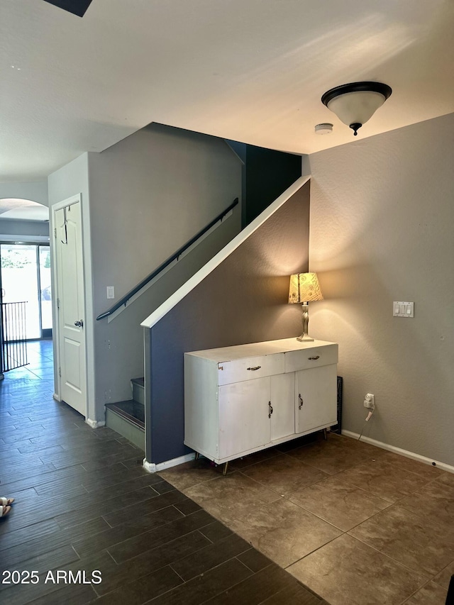 491 E Jeanne Ln, San Tan Valley, AZ 85140 - staircase featuring arched walkways, baseboards, and wood finished floors