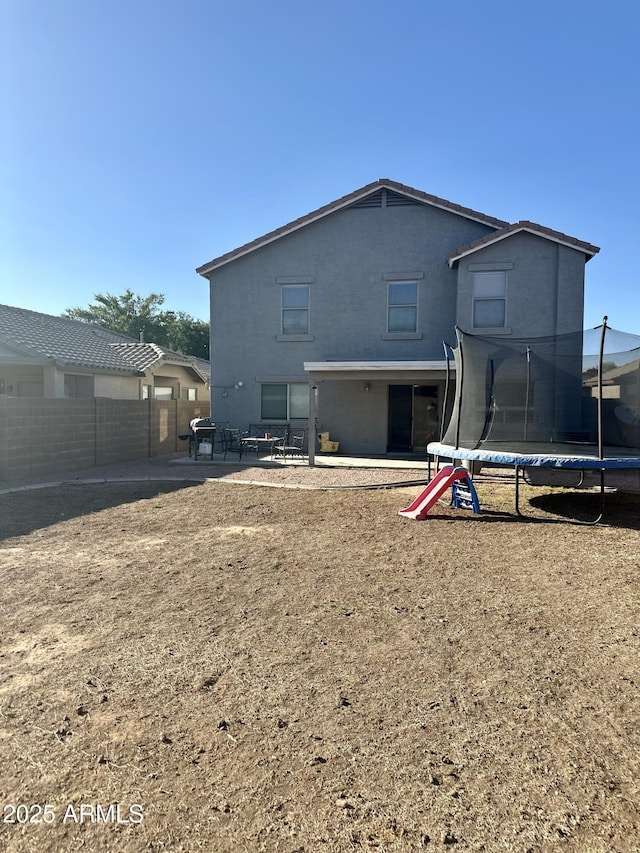 491 E Jeanne Ln, San Tan Valley, AZ 85140 - back of house with a trampoline and a patio area