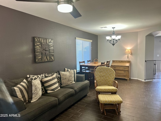 491 E Jeanne Ln, San Tan Valley, AZ 85140 - living area featuring dark wood-style flooring, arched walkways, baseboards, a ceiling fan, and a chandelier