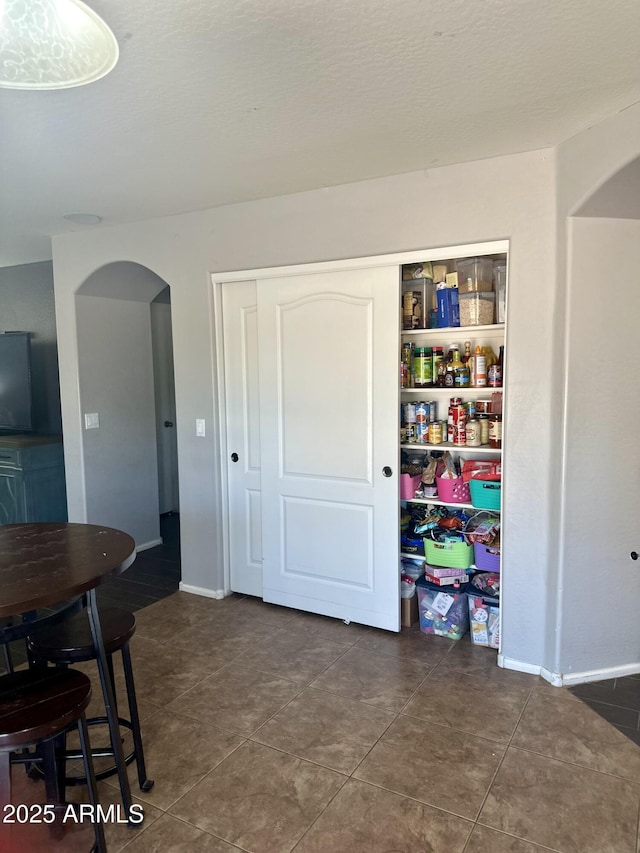 491 E Jeanne Ln, San Tan Valley, AZ 85140 - tiled dining area with arched walkways and baseboards