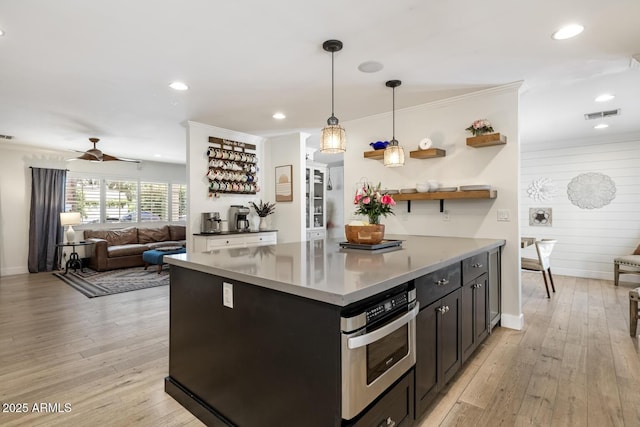 3308 N 51st St, Phoenix, AZ 85018 - kitchen with light wood-style flooring, ornamental molding, oven, pendant lighting, and a ceiling fan