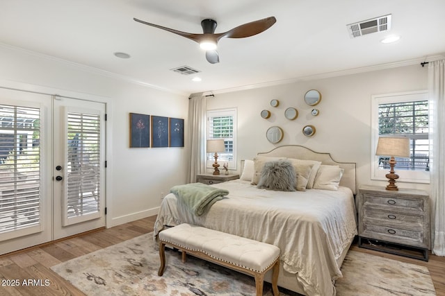 3308 N 51st St, Phoenix, AZ 85018 - bedroom with access to exterior, crown molding, multiple windows, wood finished floors, and baseboards
