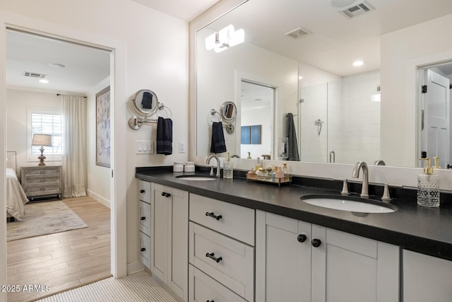 3308 N 51st St, Phoenix, AZ 85018 - bathroom with a shower stall, ensuite bathroom, double vanity, baseboards, and wood finished floors