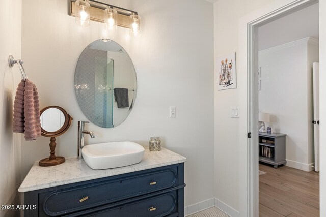 3308 N 51st St, Phoenix, AZ 85018 - bathroom with baseboards, vanity, and wood finished floors