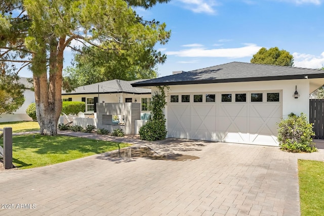 3308 N 51st St, Phoenix, AZ 85018 - view of front of house featuring an attached garage, decorative driveway, stucco siding, a front lawn, and a shingled roof