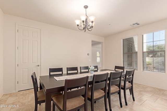 dining space featuring a healthy amount of sunlight and a notable chandelier